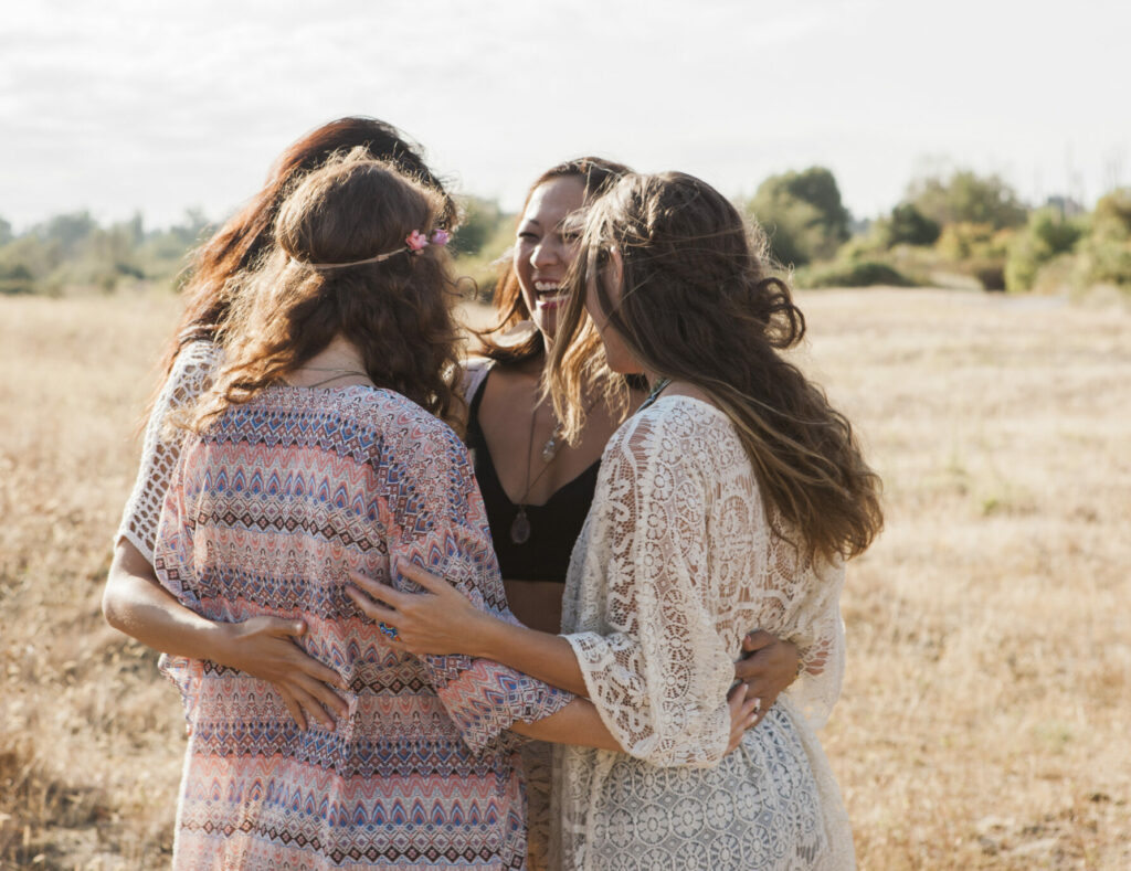 Women hugging in rural field